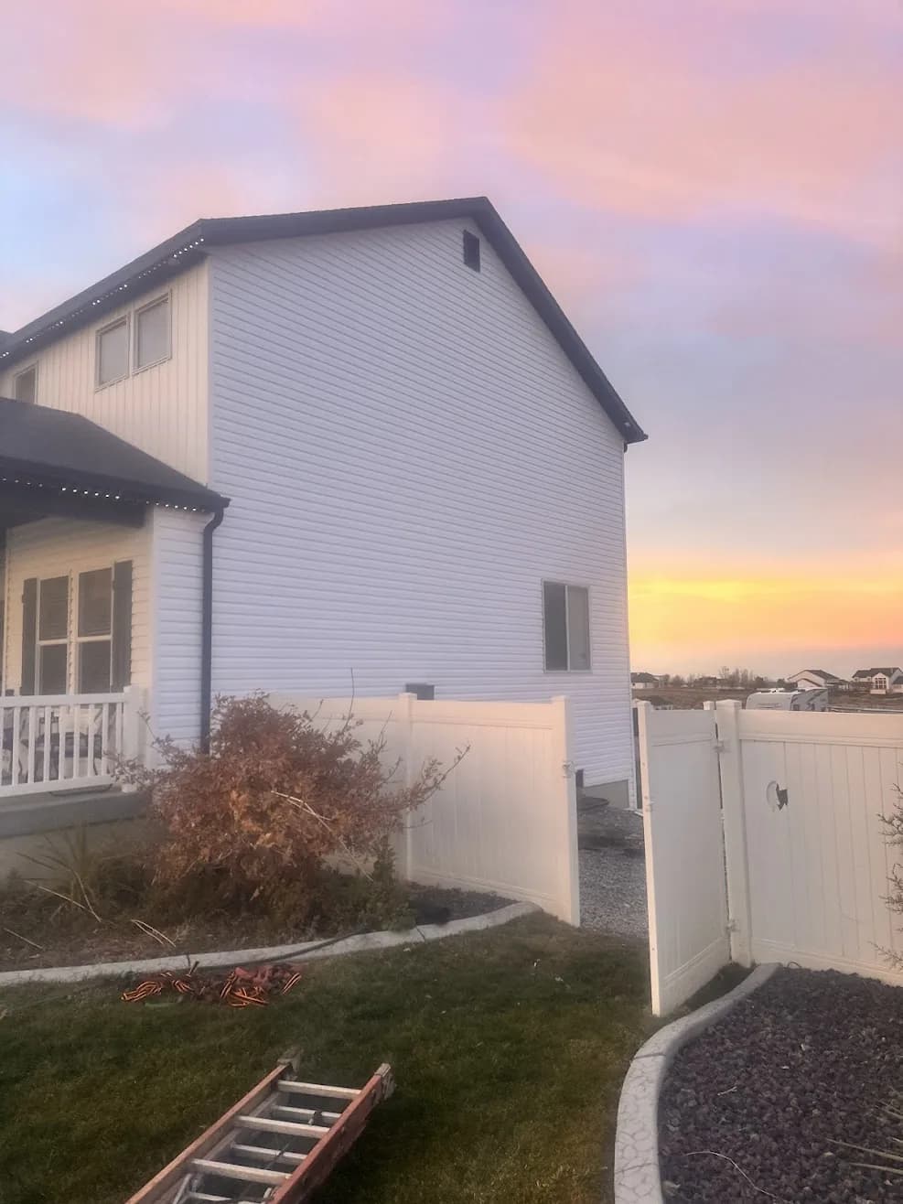 The same home after siding restoration, with clean white siding fully replaced